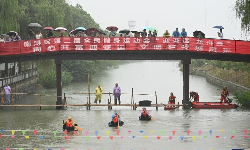 Villagers participate in a barrel rowing competition to mark the upcoming traditional Chinese Dragon Boat Festival, in Mindang Village of Hefu Town, Huzhou City, east China's Zhejiang Province, June 18, 2023. This kind of barrel is a traditional tool used by the locals to conduct agricultural activities on water including fishing, water chestnuts and lotus seedpods picking. Dragon Boat Festival, also known as Duanwu Festival, is a traditional holiday in China. (Xinhua/Huang Zongzhi)