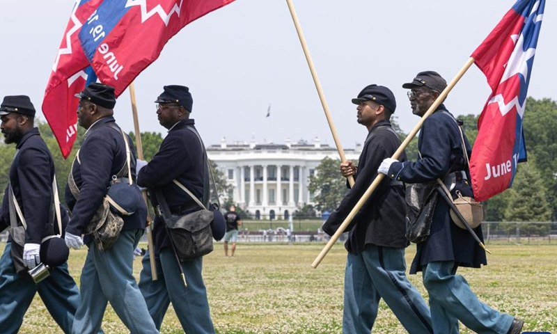 Members of a Civil War re-enactment troop are seen with the White House in the background during Juneteenth celebrations in Washington, D.C., the United States, on June 19, 2023. Celebrated on June 19, the holiday marks the day in 1865 when Union Major General Gordon Granger issued General Order No. 3 in Galveston, Texas, emancipating the remaining enslaved people in the state.(Photo: Xinhua)