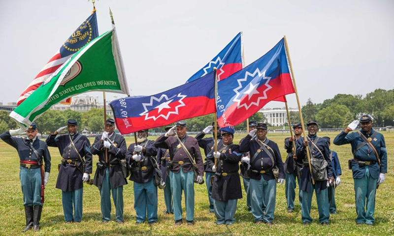 Members of a Civil War re-enactment troop are seen with the White House in the background during Juneteenth celebrations in Washington, D.C., the United States, on June 19, 2023. Celebrated on June 19, the holiday marks the day in 1865 when Union Major General Gordon Granger issued General Order No. 3 in Galveston, Texas, emancipating the remaining enslaved people in the state. (Photo: Xinhua)