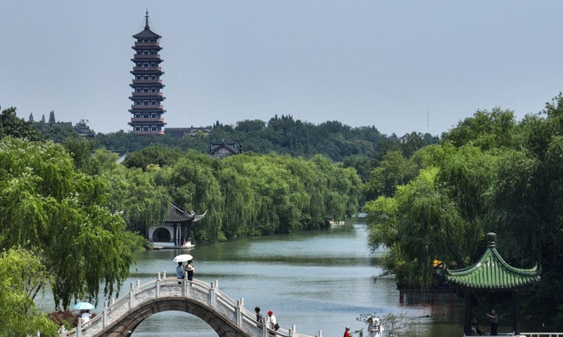 This aerial photo taken on June 15, 2023 shows people visiting the Slender West Lake scenic spot in Yangzhou, east China's Jiangsu Province. China's Grand Canal, a vast waterway connecting the northern and southern parts of China, was listed as a UNESCO World Heritage Site in 2014. Yangzhou, a scenic city through which the Grand canal runs, has been known for canal-side attractions like Slender West Lake and Sanwan canal scenic area.(Photo: Xinhua)