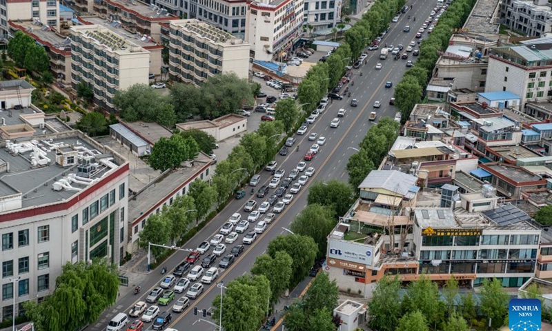 Traffics are seen in a street in Lhasa, capital of southwest China's Tibet Autonomous Region, June 15, 2023, Since the 7th century, the city of Lhasa gradually emerged in the heart of the plateau, nestled within the valley of the Lhasa River -- a tributary of the Yarlung Tsangpo River. The city's rich history spans centuries, characterized by layers of cultural heritage, thereby fostering a distinctive plateau culture that embraces diversity and inclusiveness.(Photo: Xinhua)