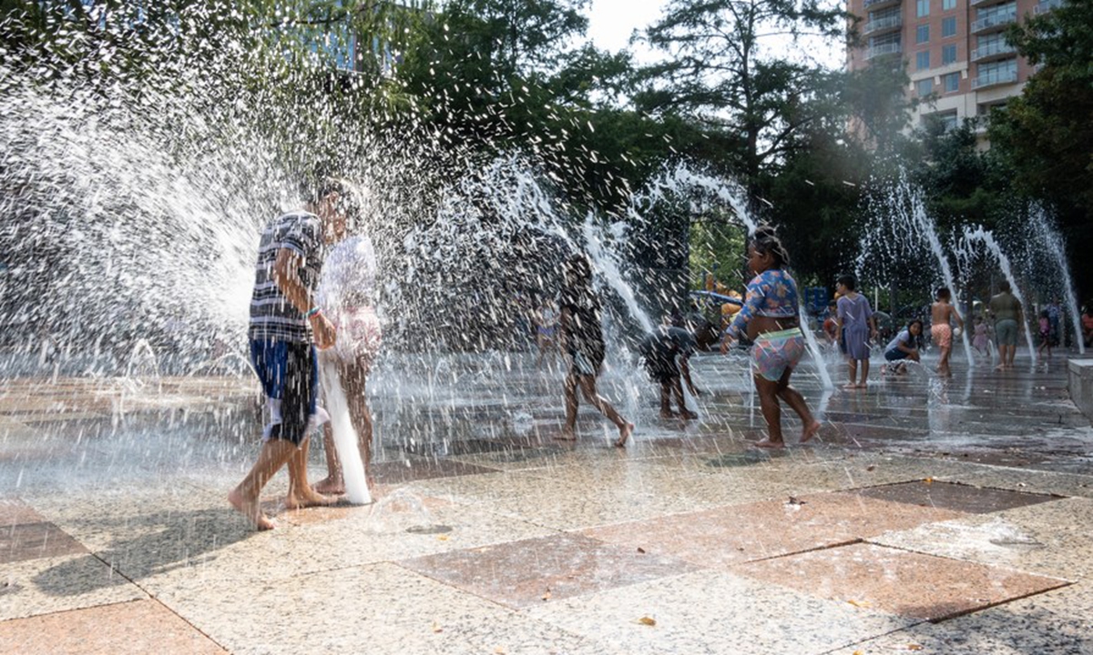 Children play and cool off at a splash park in downtown Houston, Texas, United States, on June 15, 2023.(Photo by Chen Chen/Xinhua)

