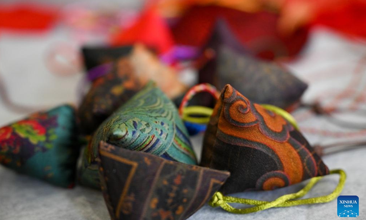 Sachets made by Chen Yuqiu are seen in Jilin, northeast China's Jilin Province, June 20, 2023. Chen Yuqiu, 55 years old, is an inheritor of the national-level intangible cultural heritage of Manchu cheongsam making. In order to make people aware of the traditional Chinese culture and Manchu cheongsam, she taught people to make sachets at the Jilin Museum and sent them to citizens before the Dragon Boat Festival. (Xinhua/Yan Linyun)