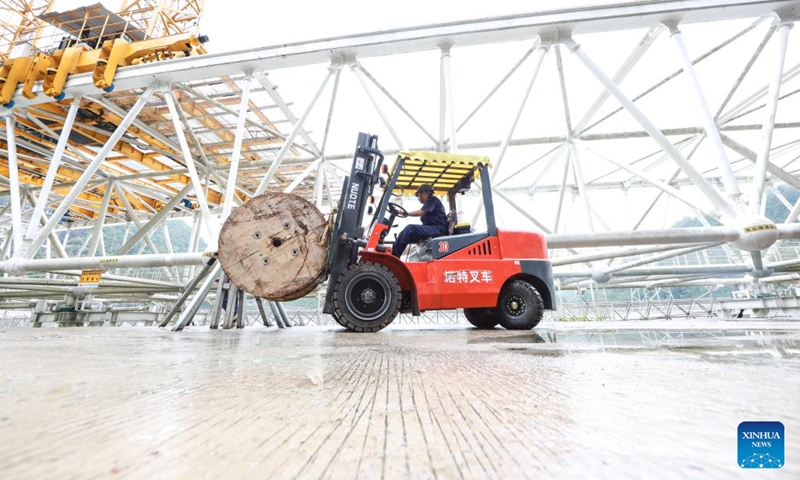 A staff member performs a regular maintenance operation on China's Five-hundred-meter Aperture Spherical Radio Telescope (FAST) in southwest China's Guizhou Province, June 22, 2023. China's FAST telescope identified a binary pulsar with an orbital period of 53.3 minutes, the shortest known period for a pulsar binary system.The research, mainly conducted by a team led by scientists from the National Astronomical Observatories of the Chinese Academy of Sciences (NAOC), was published in the journal Nature Wednesday. (Xinhua/Ou Dongqu)