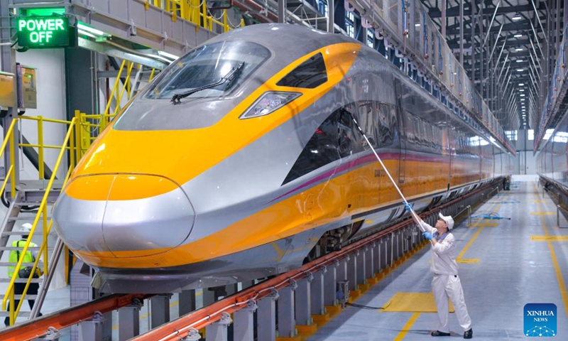 A staff member cleans a comprehensive inspection train at a workshop for the Jakarta-Bandung High-Speed Railway in Bandung, Indonesia, June 21, 2023. The comprehensive inspection train (CIT) of Jakarta-Bandung High-Speed Railway (HSR) reached 350 km per hour, the design speed, for the first time on Thursday during the joint commissioning and testing phase. (Xinhua/Xu Qin)