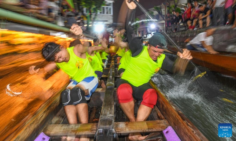 Participants attend a night training session in Diejiao Township of Foshan, south China's Guangdong Province, June 16, 2023. With a narrow and winding river, Diejiao Township holds the dragon boat race annually for the Dragon Boat Festival. Participants must drift the 25-meter-long vessel around shapes curved like S, C and L at full speed. (Xinhua/Liu Dawei)