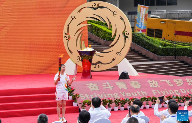 Torch bearer Li Xuerui holds the torch during the torch relay of the Chengdu 2021 FISU Summer World University Games at Chongqing University in southwest China's Chongqing Municipality, June 24, 2023. Photo: Xinhua