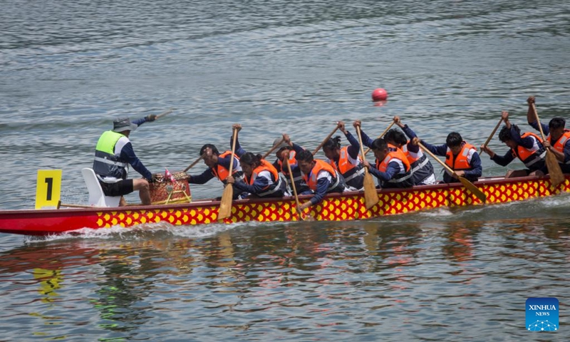 Members of a dragon boat racing team compete during a Nepal-China friendship dragon boat race festival in Pokhara, Nepal, on June 23, 2023. (Photo by Hari Maharjan/Xinhua)