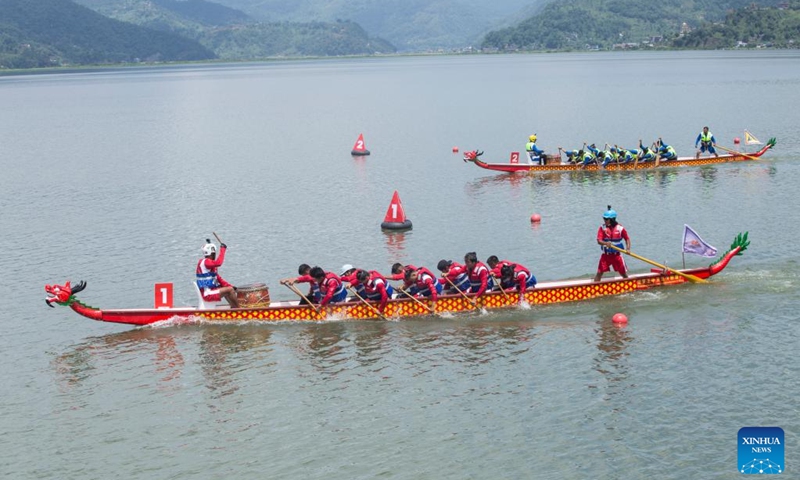 Members of dragon boat racing teams compete during a Nepal-China friendship dragon boat race festival in Pokhara, Nepal, on June 23, 2023. (Photo by Hari Maharjan/Xinhua)