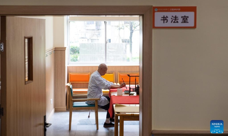 A senior resident practices calligraphy at a nursing home in Hanshou County of Changde City, central China's Hunan Province, June 20, 2023. The city of Changde has scaled up efforts to develop an elderly care service system composed mainly of in-home cares, community services, institutional and medical cares. (Xinhua/Chen Sihan)