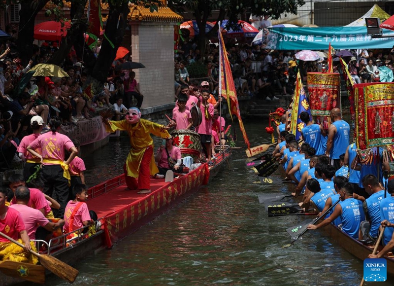 A dragon boat parade is held before the dragon boat race in Diejiao Township of Foshan, south China's Guangdong Province, June 22, 2023. With a narrow and winding river, Diejiao Township holds the dragon boat race annually for the Dragon Boat Festival. Participants must drift the 25-meter-long vessel around shapes curved like S, C and L at full speed. (Xinhua/Liu Dawei)