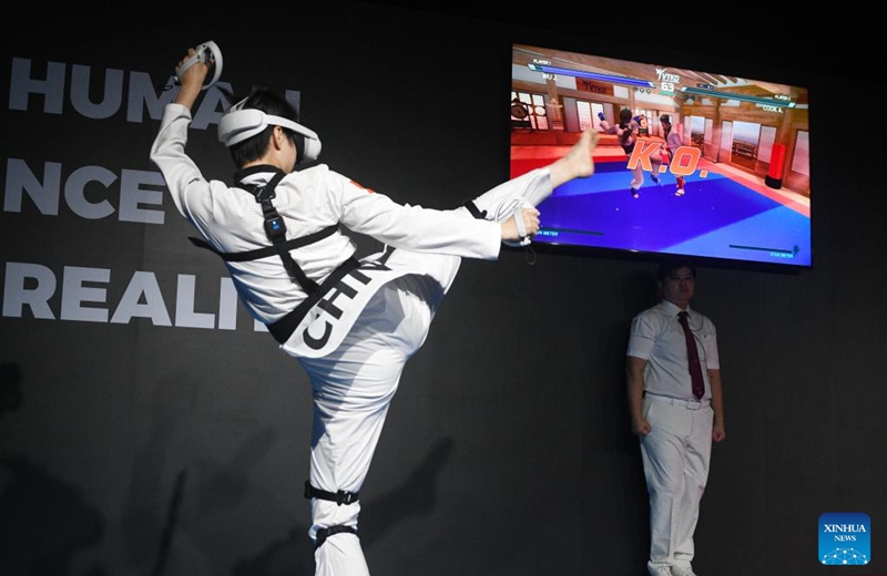 Wu Jingyu (Front) of China competes during the first round of the taekwondo event against Aaron Cook of Great Britain at the Olympic ESports Week 2023 held in Singapore on June 23, 2023. (Photo by Then Chih Wey/Xinhua)