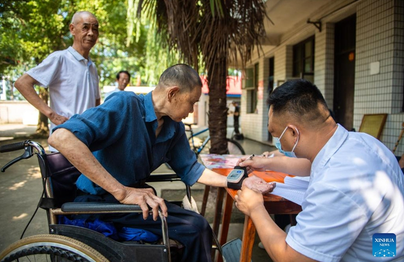 A medical worker (1st R) conducts medical examination for a senior resident at a nursing home in Anxiang County of Changde City, central China's Hunan Province, June 21, 2023.The city of Changde has scaled up efforts to develop an elderly care service system composed mainly of in-home cares, community services, institutional and medical cares. (Xinhua/Chen Sihan)