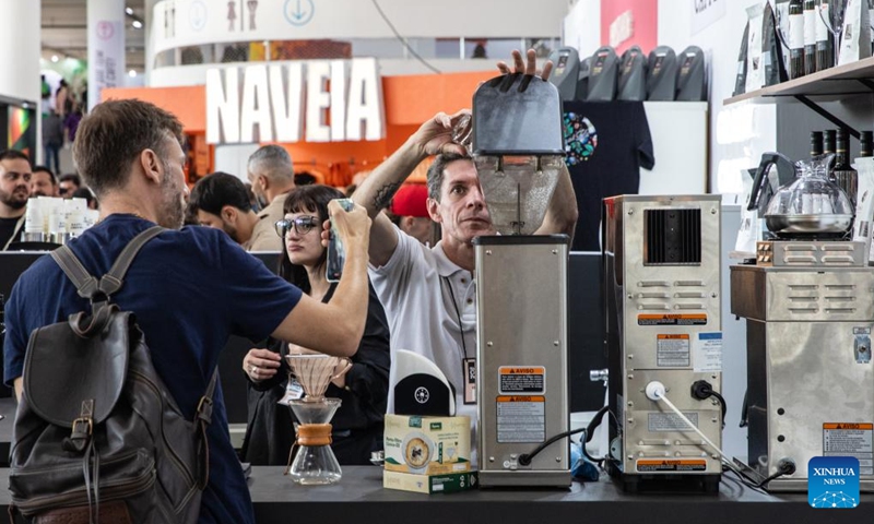 A staff member (R, front) prepares coffee during the Sao Paulo Coffee Festival in Sao Paulo, Brazil, on June 23, 2023. (Xinhua/Wang Tiancong)