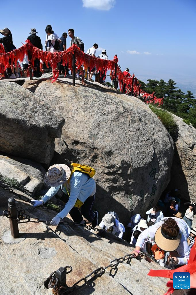 This photo taken on June 23, 2023 shows visitors on the Huashan Mountain in Weinan, northwest China's Shaanxi Province. (Photo by Zhang Lan/Xinhua)