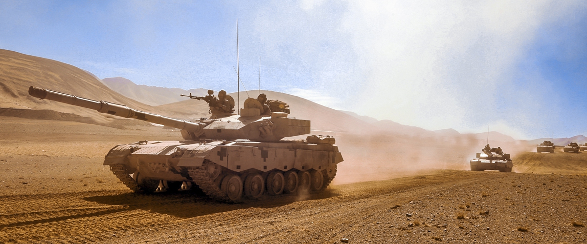 Main battle tanks attached to a brigade under the PLA 77th Group Army kick up plumes of dust as they move forward to the designated base during a maneuver operation in desert on June 7, 2023. (eng.chinamil.com.cn/Photo by Peng Jiazheng)