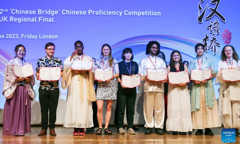 Students pose with their certificates after the 22nd Chinese Bridge Chinese Proficiency Competition in London, Britain, June 23, 2023. Students from 12 British universities competed in the regional final of the 22nd Chinese Bridge Chinese Proficiency Competition on Friday, sharing their passion for the Chinese language and culture. Photo: Xinhua