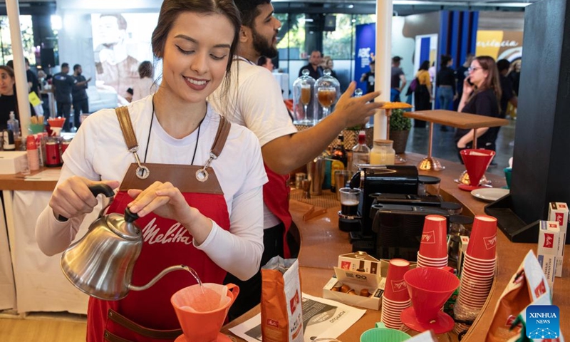 A staff member prepares coffee during the Sao Paulo Coffee Festival in Sao Paulo, Brazil, on June 23, 2023. (Xinhua/Wang Tiancong)