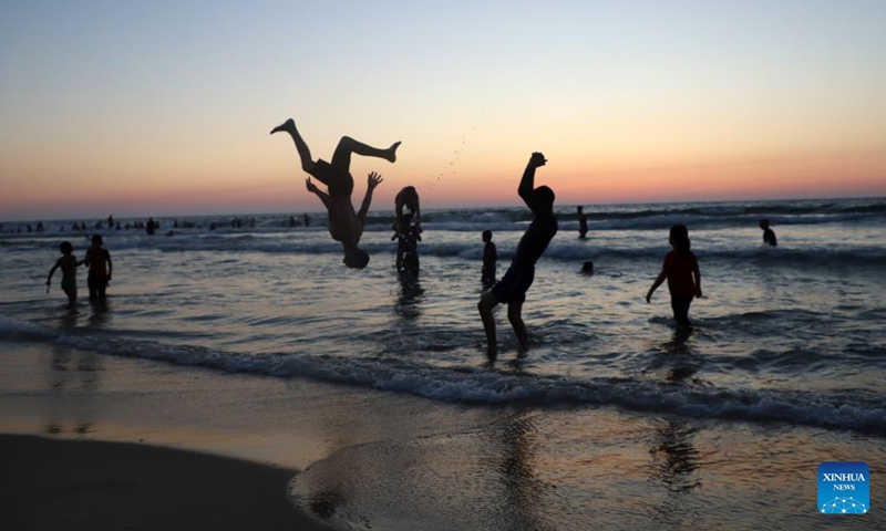 People cool off at the beach of the Mediterranean sea amid a heatwave in Gaza City, on June 23, 2023. (Photo by Rizek Abdeljawad/Xinhua)