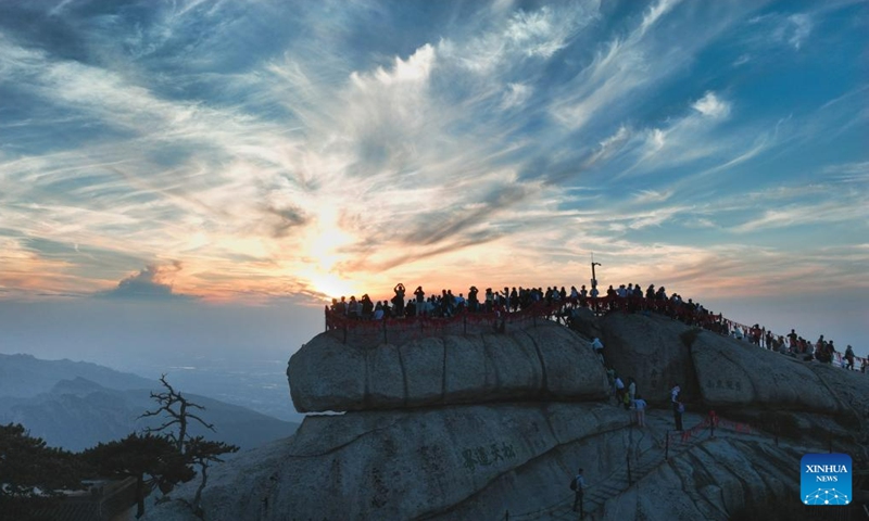 This aerial photo taken on June 23, 2023 shows visitors enjoying sunset on the Huashan Mountain in Weinan, northwest China's Shaanxi Province. (Photo by Zhang Lan/Xinhua)