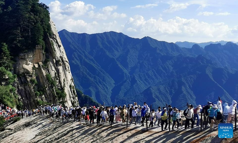 This photo taken on June 23, 2023 shows visitors on the Huashan Mountain in Weinan, northwest China's Shaanxi Province. (Photo by Zhang Lan/Xinhua)