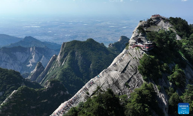 This aerial photo taken on June 23, 2023 shows visitors on the Huashan Mountain in Weinan, northwest China's Shaanxi Province. (Photo by Zhang Lan/Xinhua)