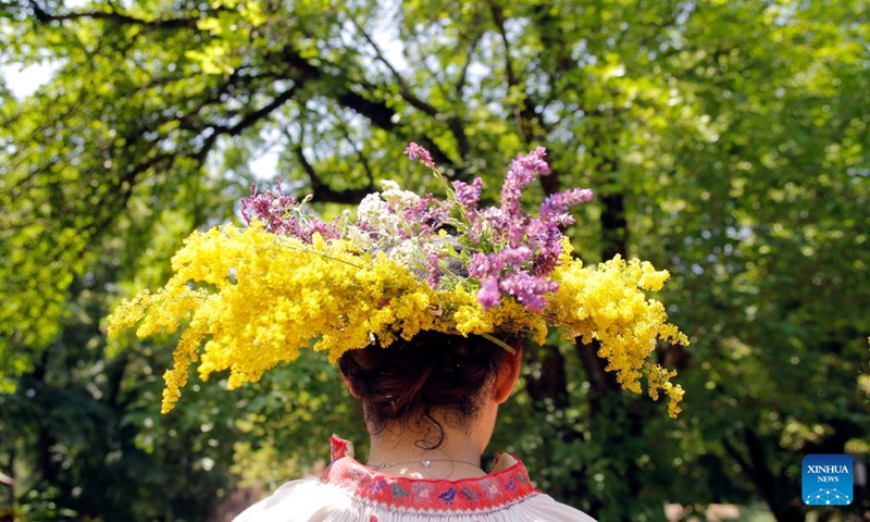 A young girl dressed as a fairy attends the traditional folk festival Sanziene in Bucharest, capital of Romania, June 24, 2023. Ancient traditions mention Sanzienele as gentle fairies that come around summer solstice to bring good luck and good harvest. (Photo by Cristian Cristel/Xinhua)