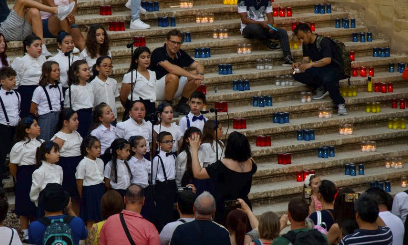 Children sing at the Cittadella on the island of Gozo, Malta, on June 30, 2023. A festival of lights was held at the Cittadella on the island of Gozo, Malta, on Friday night, during which more than 30,000 candles were lit up. (Photo by Jonathan Borg/Xinhua)