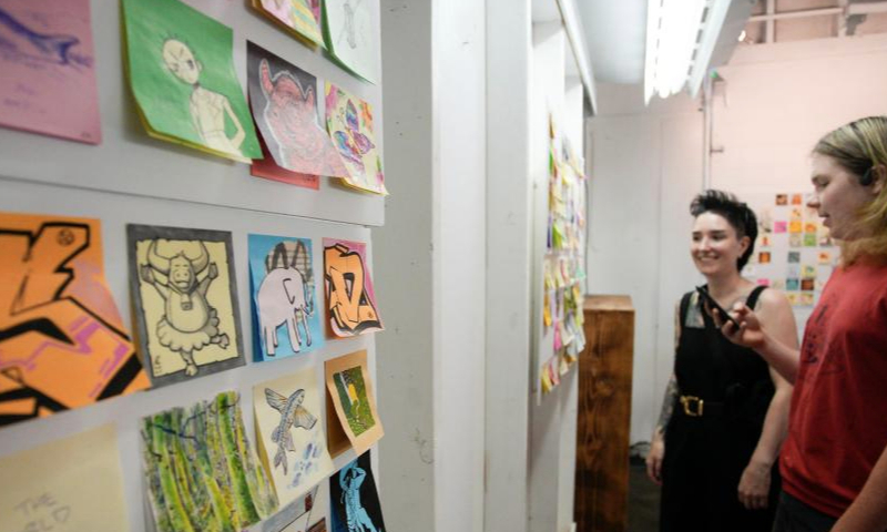 Visitors look at some artworks during the Post-it Note Art Show in Vancouver, British Columbia, Canada, on July 8, 2023. (Photo by Liang Sen/Xinhua)