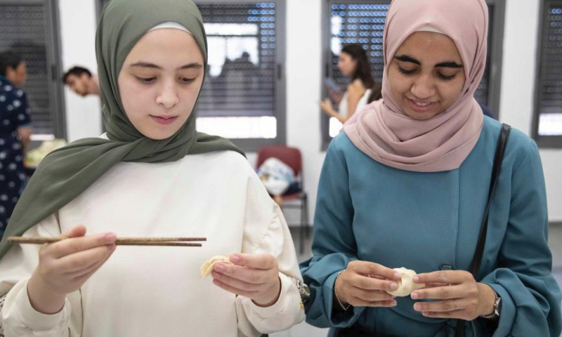 Students learn to make dumplings during a workshop to promote the broad and profound Chinese cuisine culture at an activity center in Wadi Joz, an Arab neighborhood in East Jerusalem, June 26, 2023. (Xinhua/Chen Junqing)