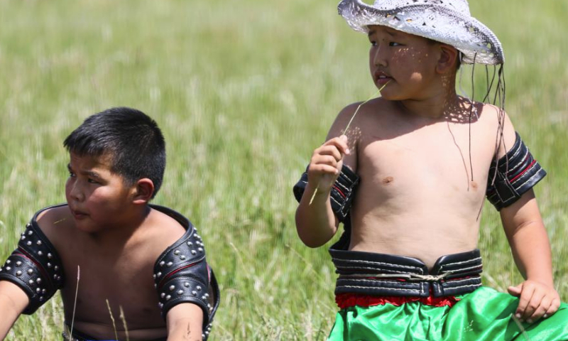 Young contestants prepare for a Mongolian wrestling competition in Hulun Buir, north China's Inner Mongolia Autonomous Region, July 1, 2023. The second edition of the Hulun Buir grassland culture and tourism festival kicked off here on Saturday, attracting nationwide tourists with various performances of folk culture. (Xinhua/Lan Hongguang)