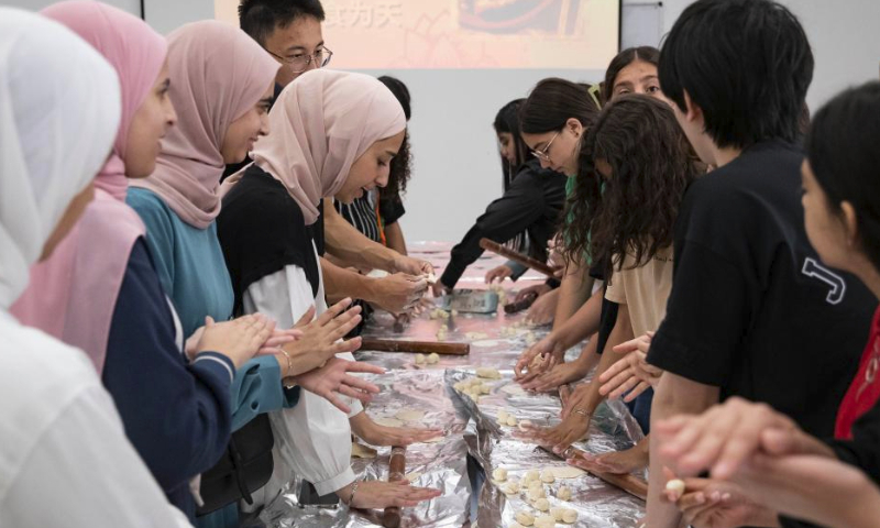 Students learn to make dumplings during a workshop to promote the broad and profound Chinese cuisine culture at an activity center in Wadi Joz, an Arab neighborhood in East Jerusalem, June 26, 2023. (Xinhua/Chen Junqing)