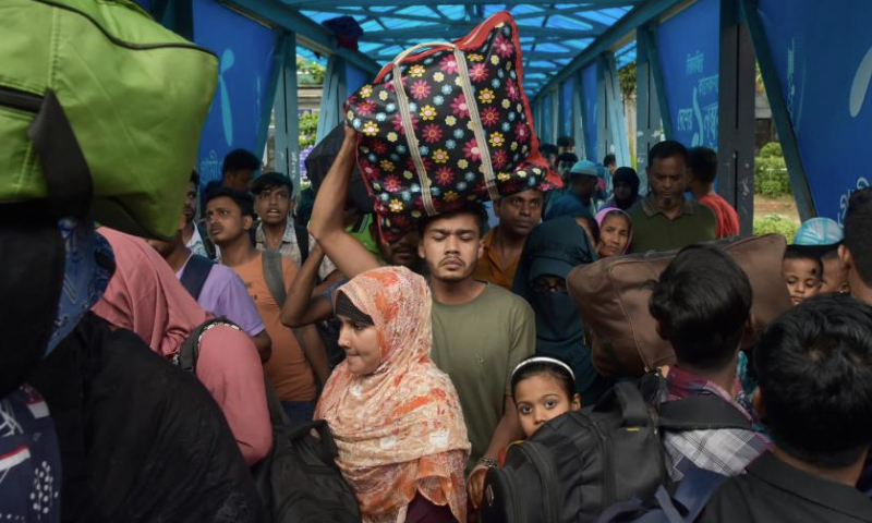 People arrive to board ferries at Sadarghat terminal ahead of Eid al-Adha in Dhaka, Bangladesh, on June 27, 2023. As Eid al-Adha approaches, many people from Dhaka have streamed out of the city to join the festival with their kith and kin in village homes. (Xinhua)