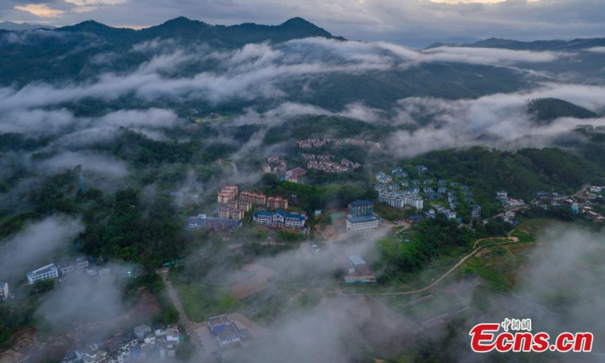 Wuzhi Mountain is shrouded by orange clouds at dusk at Hainan Tropical Rainforest National Park in south China's Hainan Province, June 29, 2023. Photo:China News Service