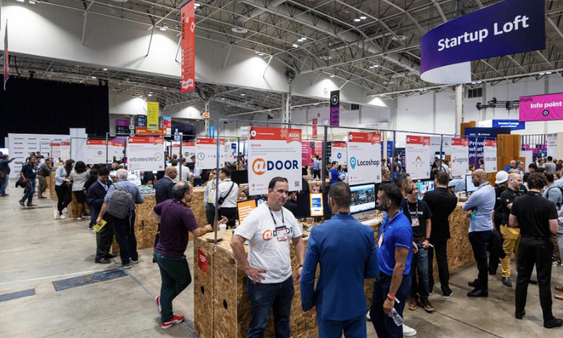 People visit start-ups' booths during the 2023 Collision Conference in Toronto, Canada, on June 27, 2023. The 2023 Collision Conference, an annual tech conference in North America, is held here from June 26 to June 29 this year. (Photo by Zou Zheng/Xinhua)