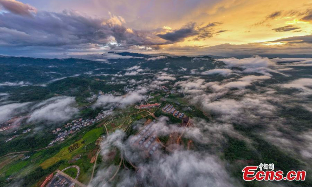 Wuzhi Mountain is shrouded by orange clouds at dusk at Hainan Tropical Rainforest National Park in south China's Hainan Province, June 29, 2023. Photo:China News Service