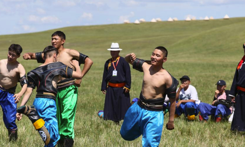 Young contestants warm up ahead of a Mongolian wrestling competition in Hulun Buir, north China's Inner Mongolia Autonomous Region, July 1, 2023. The second edition of the Hulun Buir grassland culture and tourism festival kicked off here on Saturday, attracting nationwide tourists with various performances of folk culture. (Xinhua/Lan Hongguang)