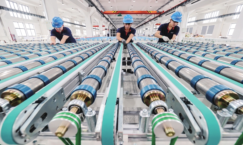 Staff members work on a glass production line on June 27, 2023 in Huzhou, East China's Zhejiang Province. The company's smart production line was put into operation in March, and the products have been hugely welcomed by consumers in the Yangtze River Delta region and countries along the Belt and Road. Photo: cnsphoto