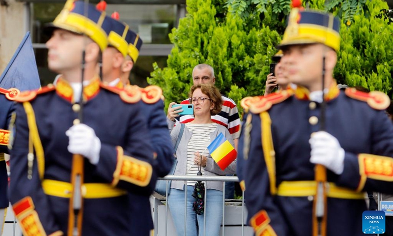 A woman takes pictures during a ceremony marking Romania's National Flag Day in Bucharest, Romania, on June 26, 2023.(Photo: Xinhua)