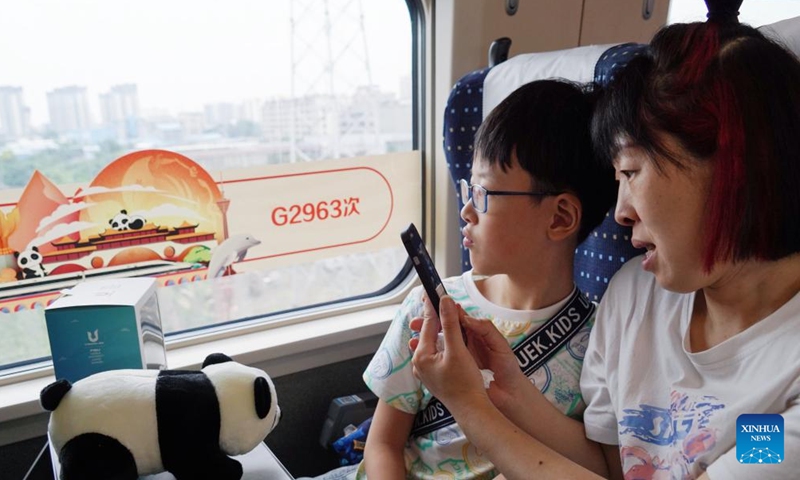 Passengers take photos on the high-speed train G2963 on July 1, 2023.

The train started on Saturday morning from Chengdu, the capital of southwest China's Sichuan Province, heading for Hong Kong.

It marked the opening of a direct high-speed train service between Chengdu and Hong Kong. (Xinhua/Xing Tuo)