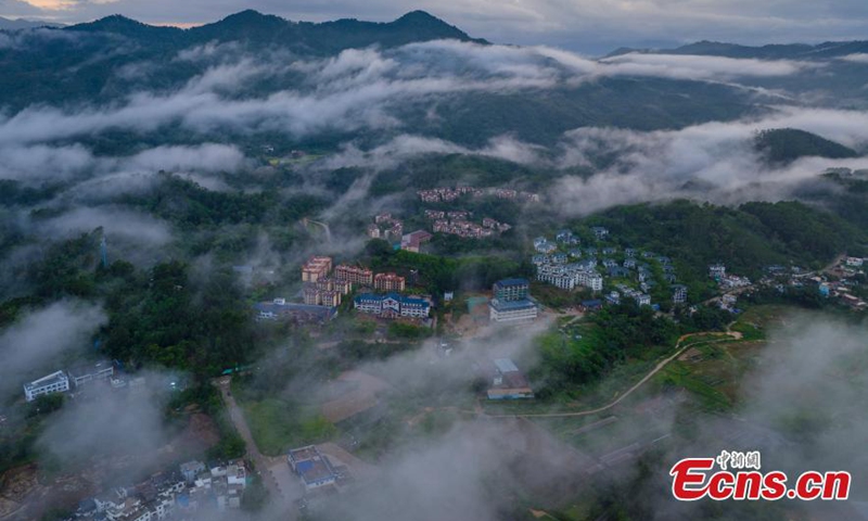 Wuzhi Mountain is shrouded by orange clouds at dusk at Hainan Tropical Rainforest National Park in south China's Hainan Province, June 29, 2023. (Photo: China News Service/Luo Yunfei)