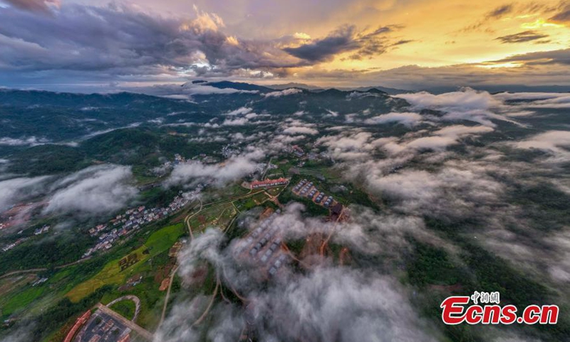 Wuzhi Mountain is shrouded by orange clouds at dusk at Hainan Tropical Rainforest National Park in south China's Hainan Province, June 29, 2023. (Photo: China News Service/Luo Yunfei)