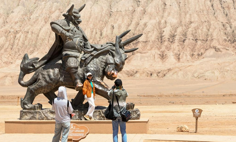 Tourists visit the Flaming Mountain scenic area in Turpan, northwest China's Xinjiang Uygur Autonomous Region, June 27, 2023. The city of Turpan has received 2.53 million tourist visits from June 1 to 28, an increase of nearly 40 percent over the same period in 2022. (Photo: Xinhua)