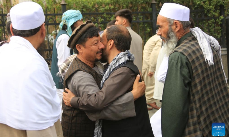 People embrace each other during Eid al-Adha in Kabul, capital of Afghanistan, on June 28, 2023. Afghans celebrated Eid al-Adha on Wednesday, one of the largest annual religious festivals observed by Muslims worldwide, amid tight security. (Photo: Xinhua)