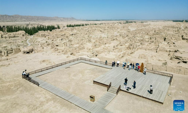 In this aerial photo, tourists visit the Flaming Mountain scenic area in Turpan, northwest China's Xinjiang Uygur Autonomous Region, June 27, 2023.The city of Turpan has received 2.53 million tourist visits from June 1 to 28, an increase of nearly 40 percent over the same period in 2022. (Photo: Xinhua)