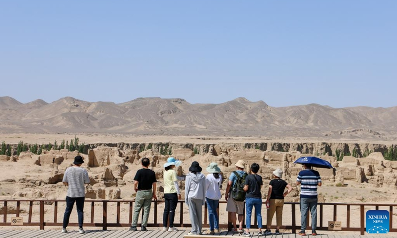 Tourists visit the Jiaohe Ruins, a world cultural heritage site, in Turpan, northwest China's Xinjiang Uygur Autonomous Region, June 25, 2023. The city of Turpan has received 2.53 million tourist visits from June 1 to 28, an increase of nearly 40 percent over the same period in 2022. (Xinhua/Hao Zhao)