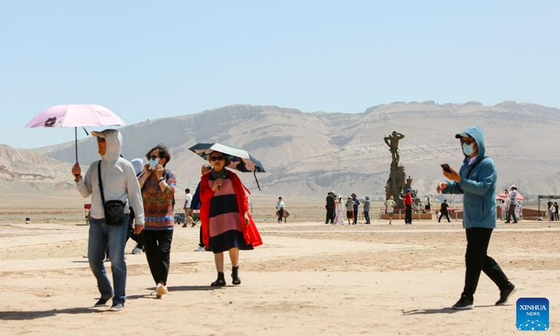 Tourists visit the Flaming Mountain scenic area in Turpan, northwest China's Xinjiang Uygur Autonomous Region, June 27, 2023. The city of Turpan has received 2.53 million tourist visits from June 1 to 28, an increase of nearly 40 percent over the same period in 2022. (Photo: Xinhua)