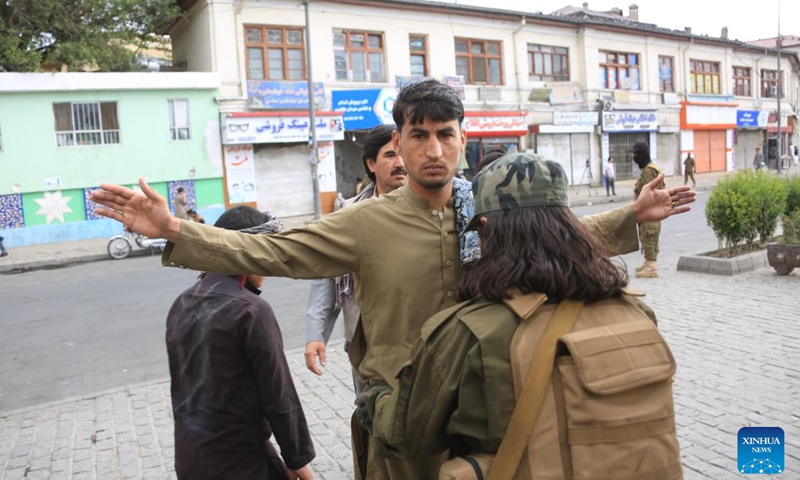 A security official frisks a man in front of a mosque in Kabul, capital of Afghanistan, on June 28, 2023. Afghans celebrated Eid al-Adha on Wednesday, one of the largest annual religious festivals observed by Muslims worldwide, amid tight security. (Photo: Xinhua)