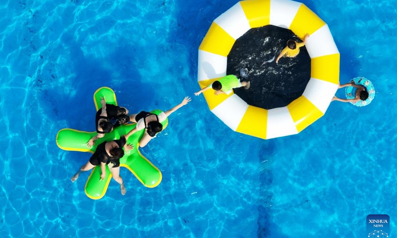 This aerial photo taken on June 28, 2023 shows people playing at a water amusement park in Yangzhou, east China's Jiangsu Province.(Photo: Xinhua)