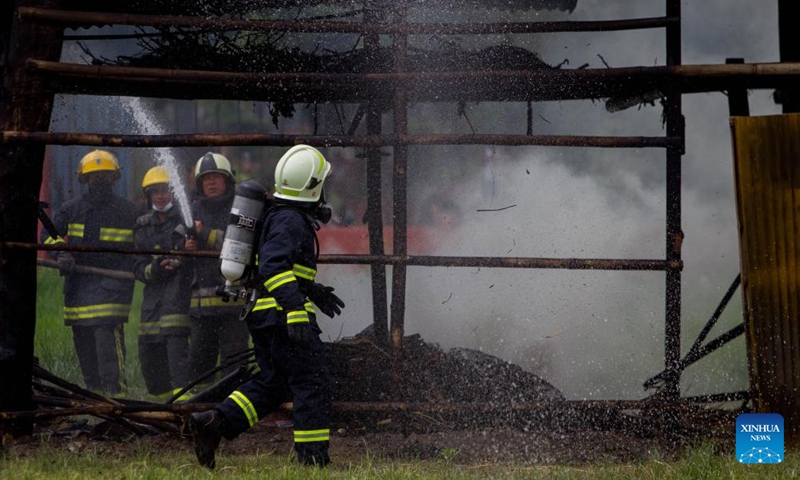 Firefighters try to put out the fire during a fire drill in Kathmandu, Nepal, July 2, 2023. (Photo by Sulav Shrestha/Xinhua)